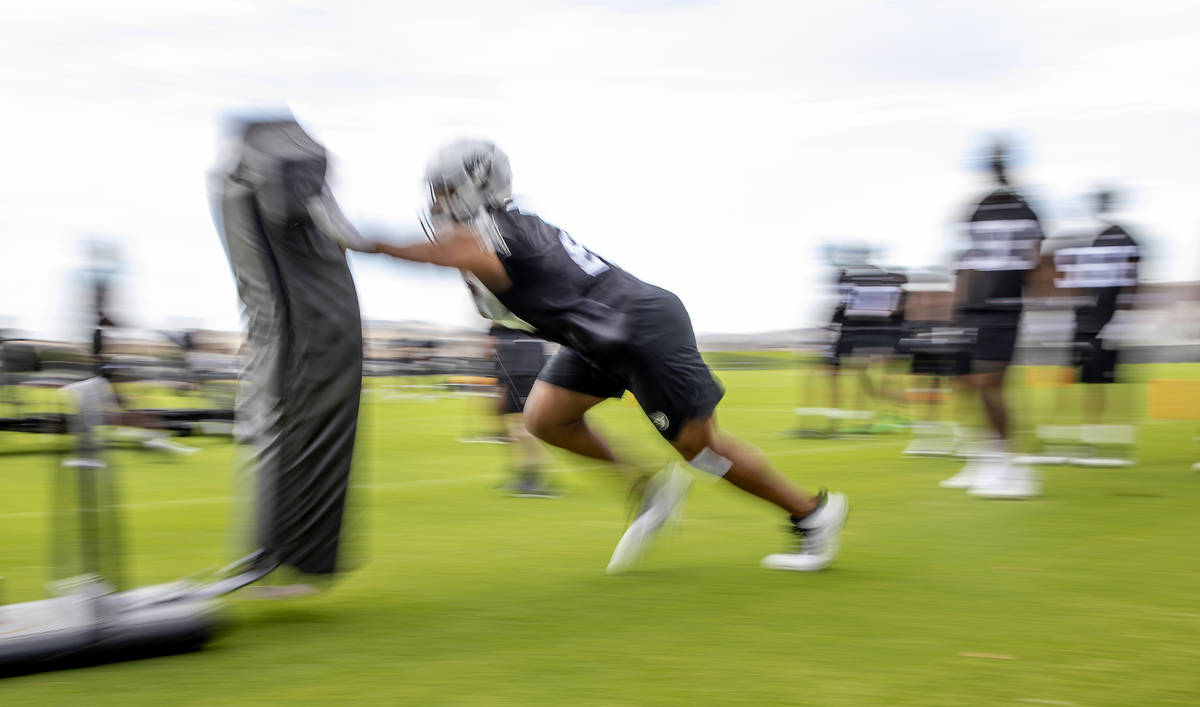 A Raiders defensive player hits a tackling sled during training camp at the Intermountain Healt ...