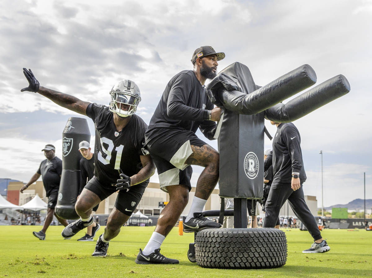 Raiders defensive end Yannick Ngakoue (91) curls around an obstacle during training camp at the ...