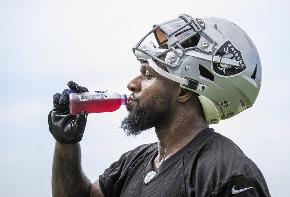 Raiders defensive end Yannick Ngakoue (91) hydrates during training camp at the Intermountain H ...