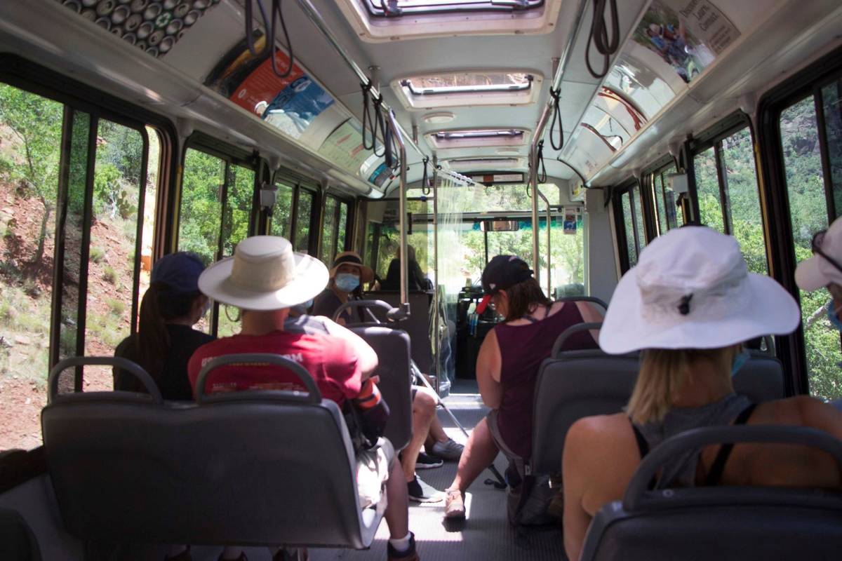 A visitors to Zion National Park, Utah ride a shuttle bus on Wednesday, July 1, 2020. (K. Sophi ...