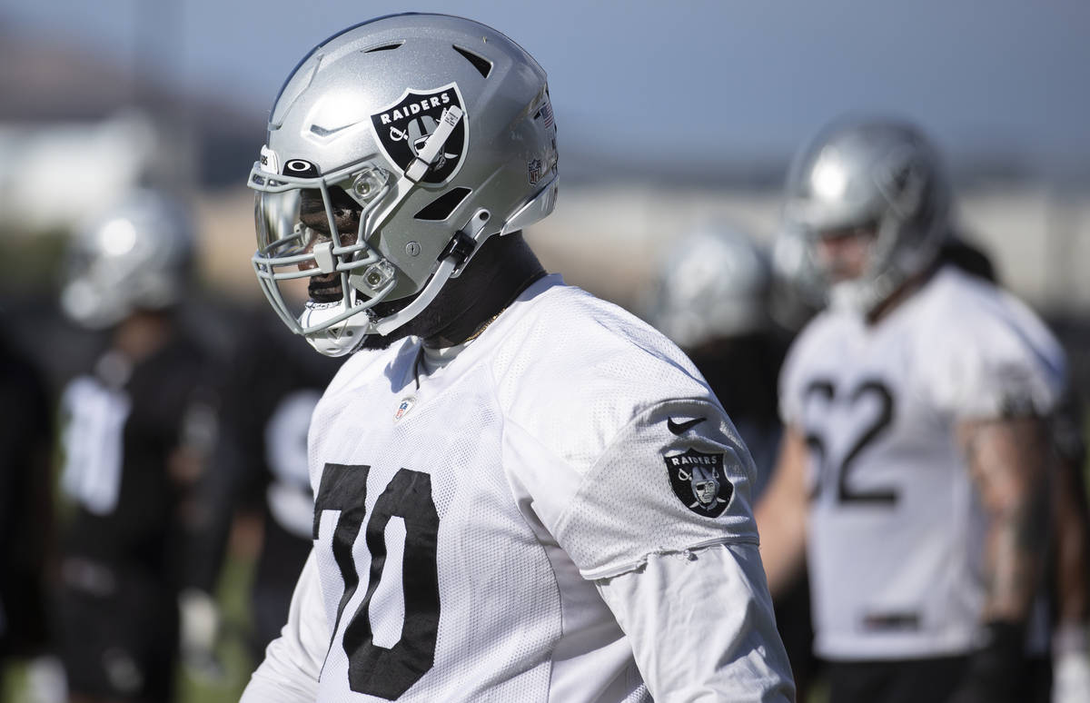 Raiders offensive tackle Alex Leatherwood (70) works through drills during training camp on Sat ...