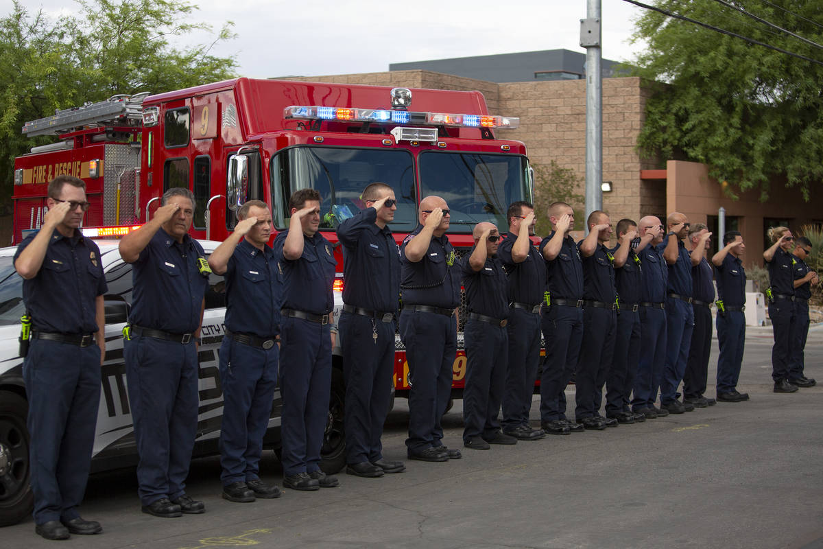 Law enforcement salutes to a procession transporting Nevada Highway Patrol trooper Micah May's ...