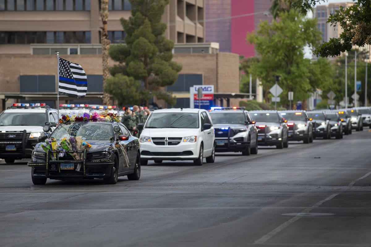 The body of a slain Nevada Highway Patrol Trooper Micah May is moved to the Clark County corone ...