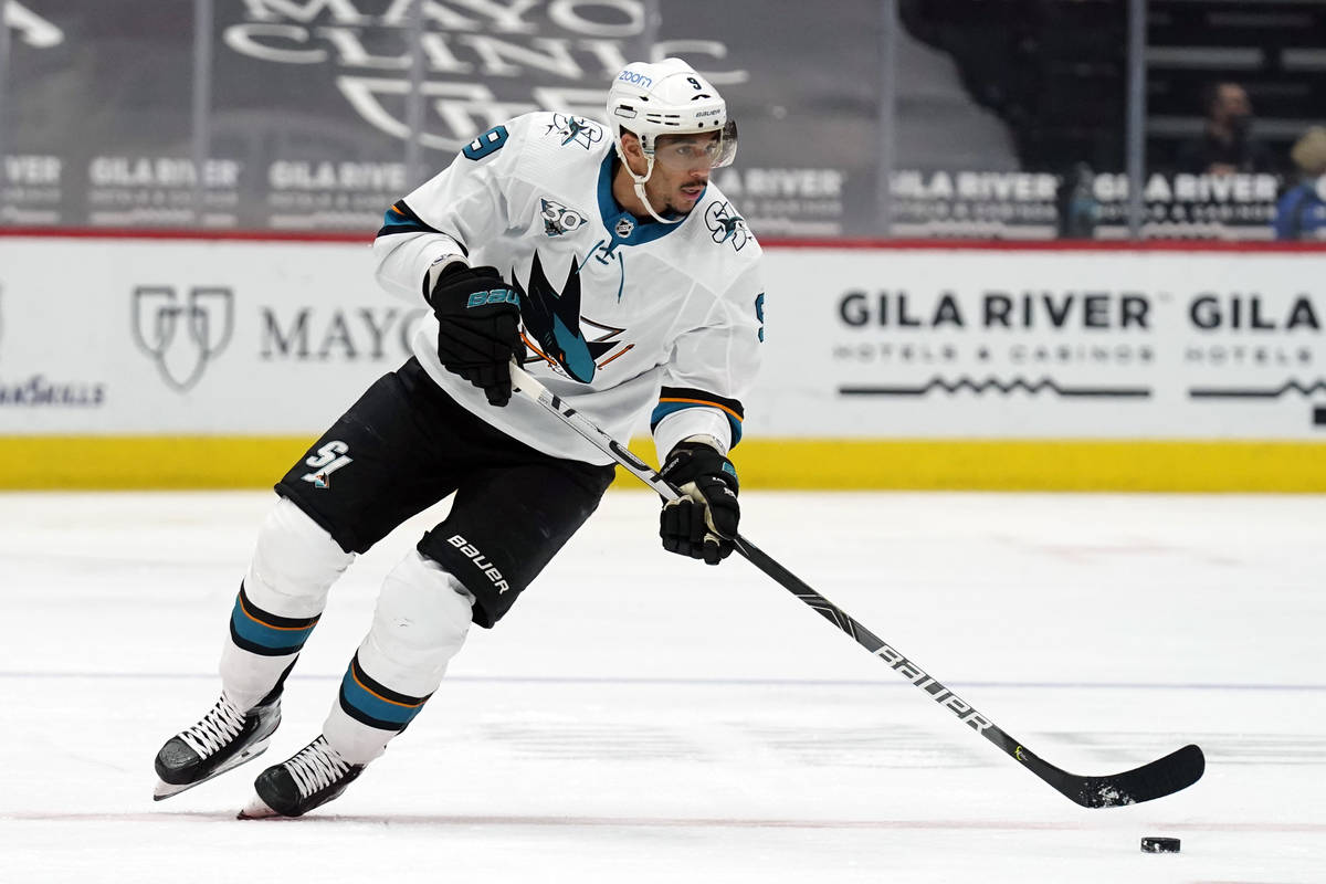 In this March 26, 2021, file photo, San Jose Sharks left wing Evander Kane moves the puck durin ...