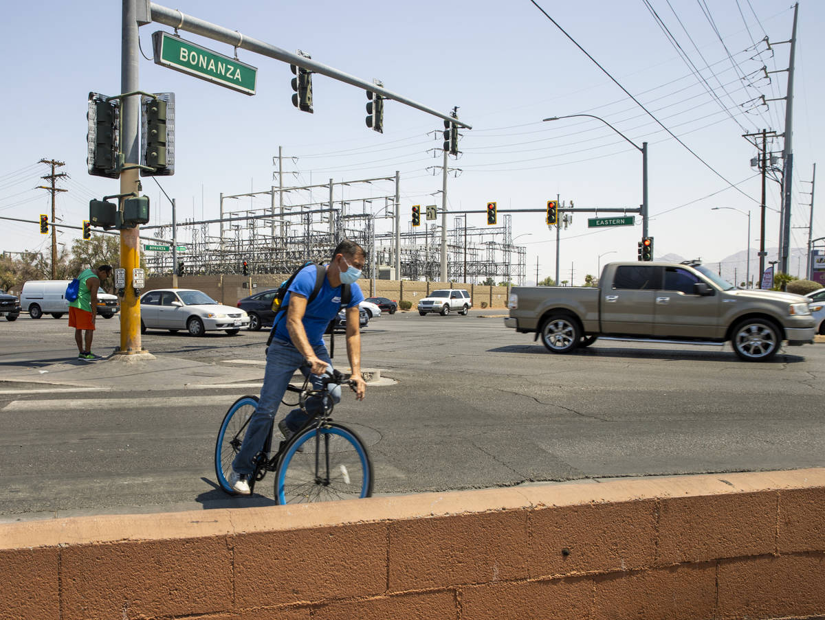 A cyclist pedals about the intersection of North Eastern Avenue and East Bonanza Road which is ...