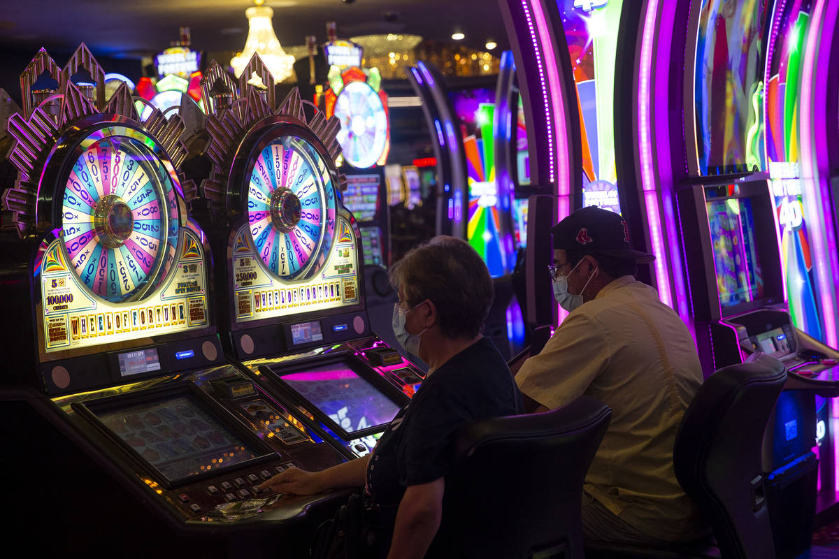 Gamblers try their luck in the Wheel of Fortune slots zone at the Plaza Hotel and Casino on Fri ...