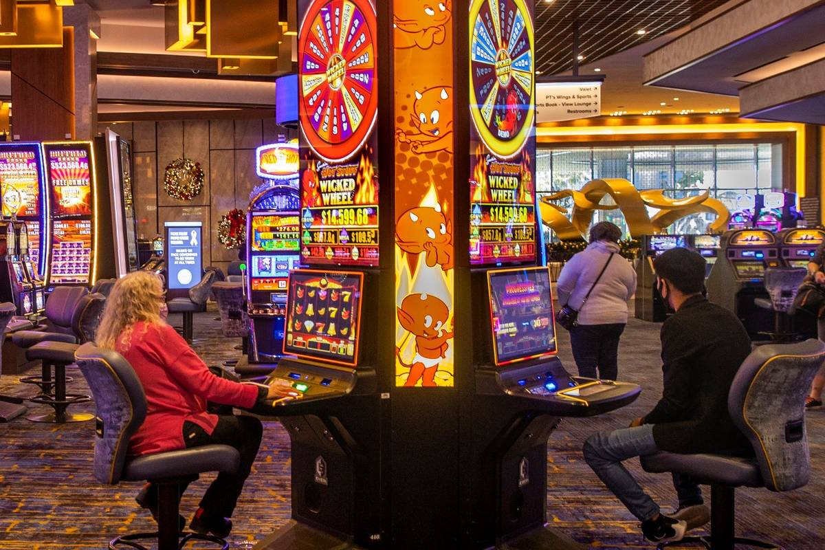 A few slot machines are played on the casino floor at the Strat in December 2020 in Las Vegas. ...