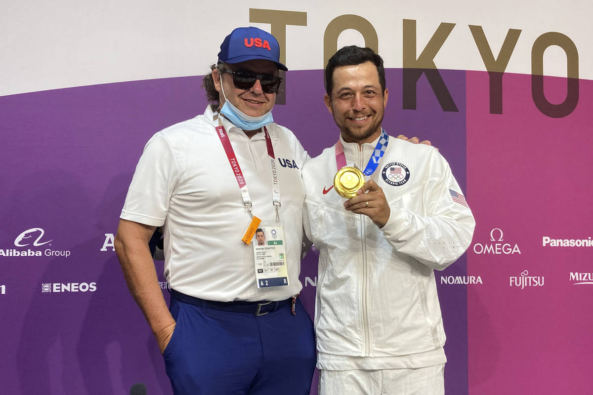 Xander Schauffele, of the United States, poses with his gold medal in the men's golf event with ...