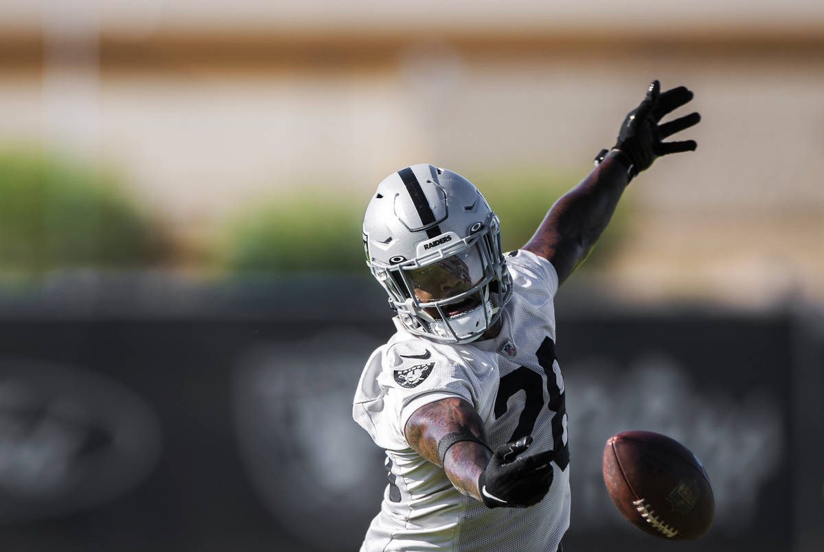 Raiders running back Josh Jacobs (28) attempts to make a catch during training camp on Monday, ...