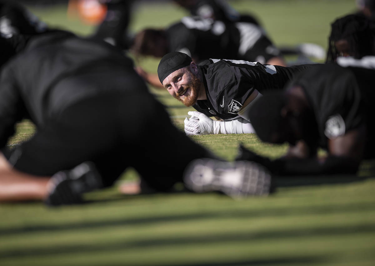 Raiders defensive end Maxx Crosby (98) stretches during training camp on Monday, Aug. 2, 2021, ...