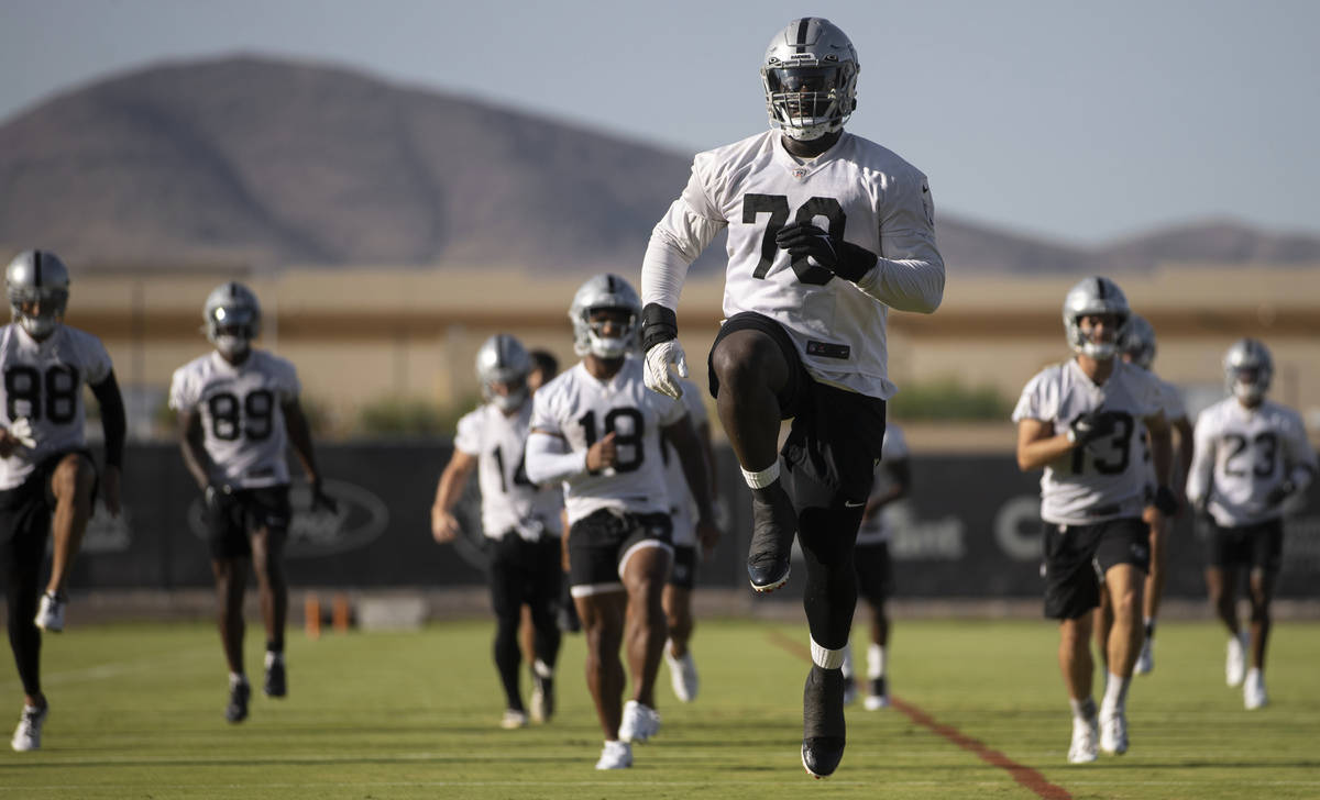 Raiders offensive tackle Alex Leatherwood (70) stretches during training camp on Monday, Aug. 2 ...