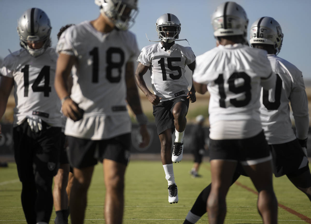 Raiders wide receiver John Brown (15) leaps in the air while stretching at training camp on Mon ...