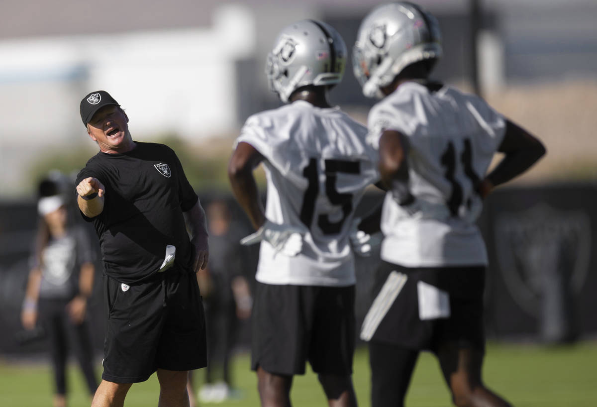 Raiders head coach Jon Gruden, left, coach up Raiders wide receiver John Brown (15) and Raiders ...