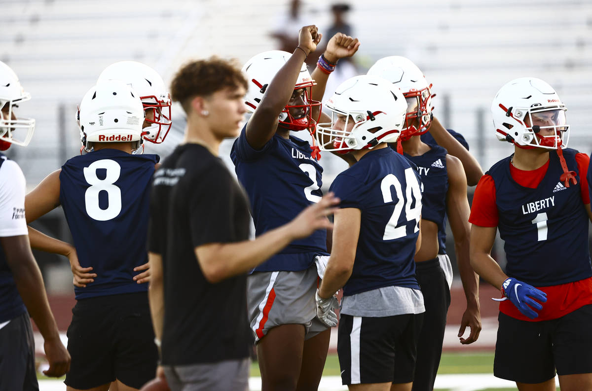 Liberty players, incuding receiver Germie Bernard, huddle during football practice in Henderson ...