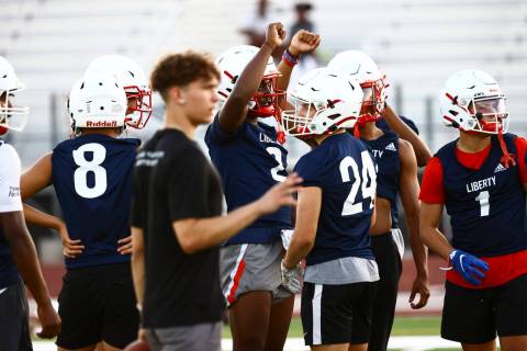 Liberty players, incuding receiver Germie Bernard, huddle during football practice in Henderson ...
