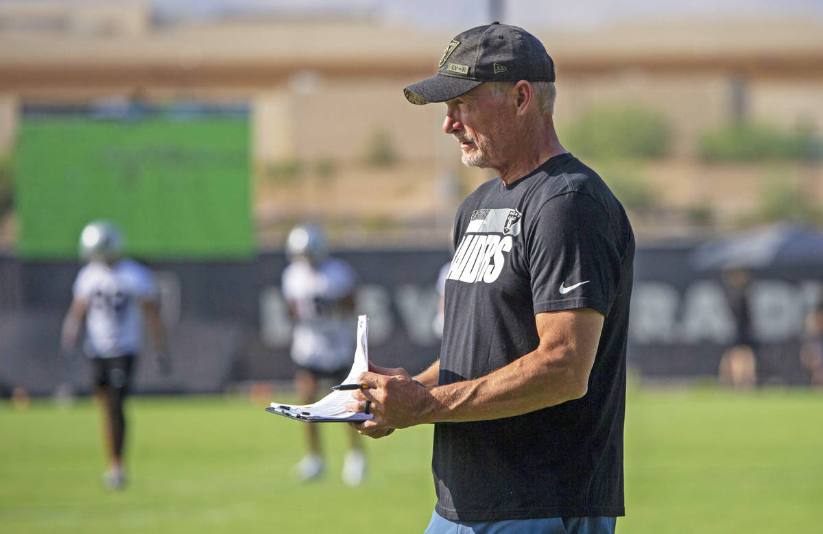 Raiders general manager Mike Mayock takes notes watching the offensive line during their NFL tr ...
