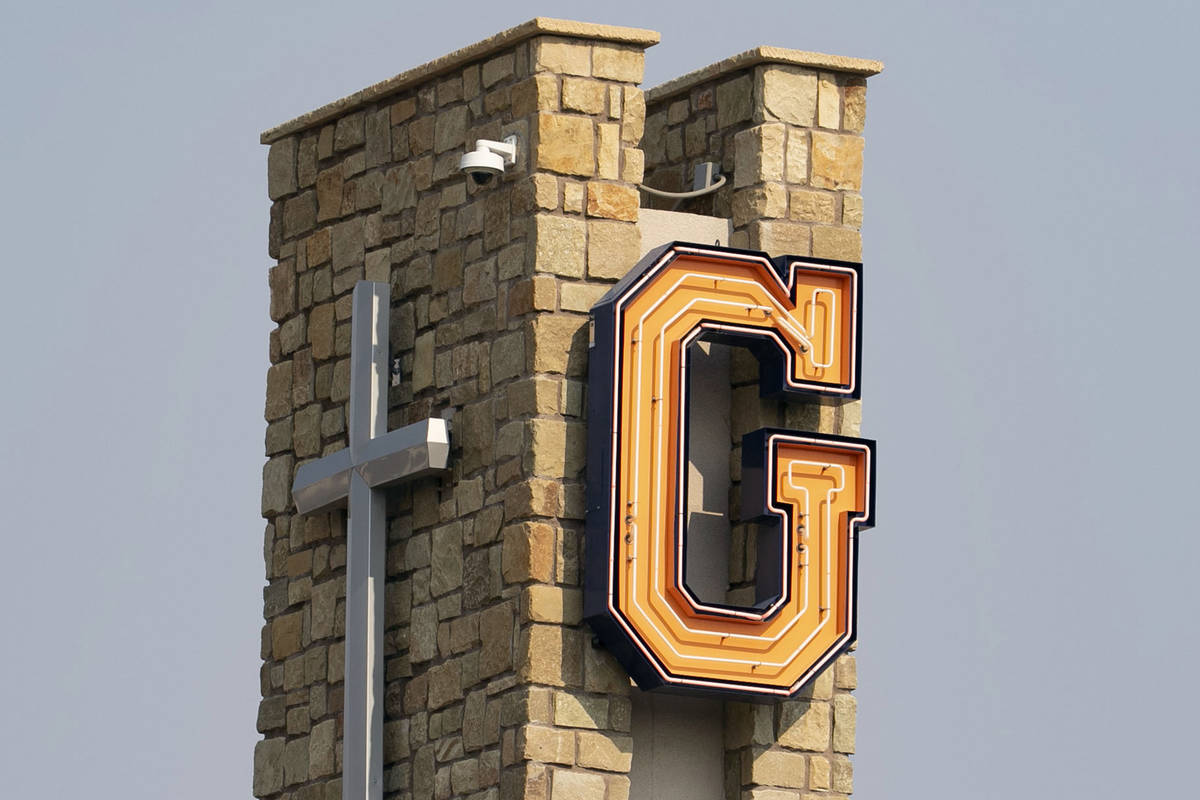 A cross and Bishop Gorman Catholic High School’s logo are photographed on Friday, Aug. 21, 20 ...