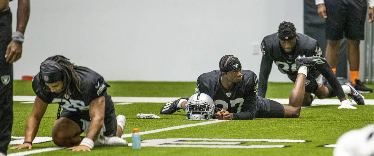 Raiders cornerback Trayvon Mullen (27) looks to teammates while stretching during practice at t ...