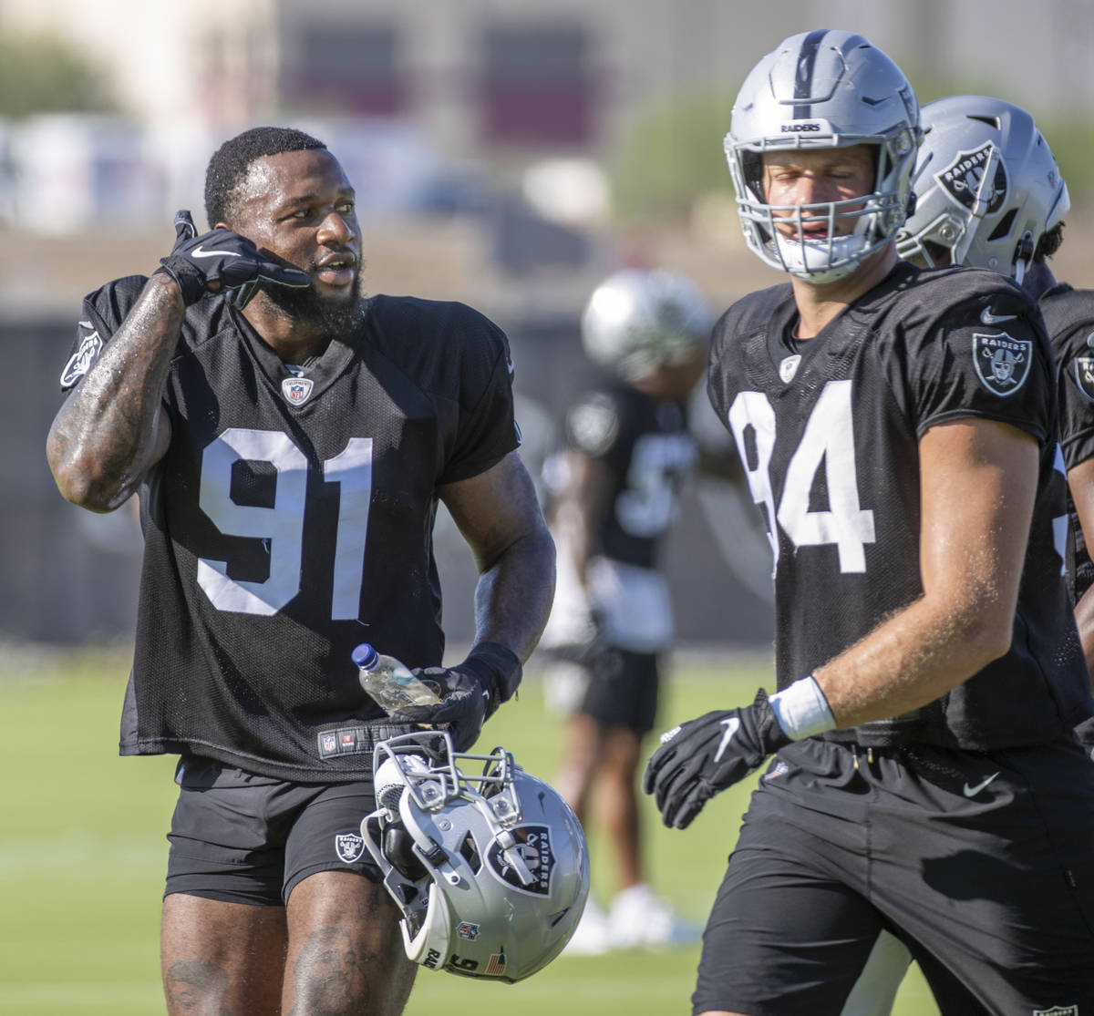 Raiders defensive end Yannick Ngakoue (91) signals a teammate to call him during practice at th ...