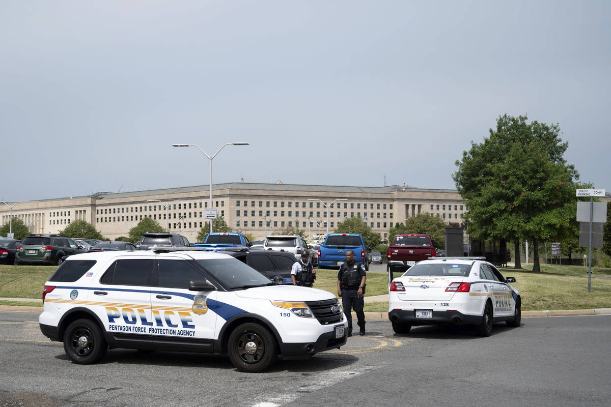 Police block off an entrance to the Pentagon following reports of multiple gun shots fired on a ...