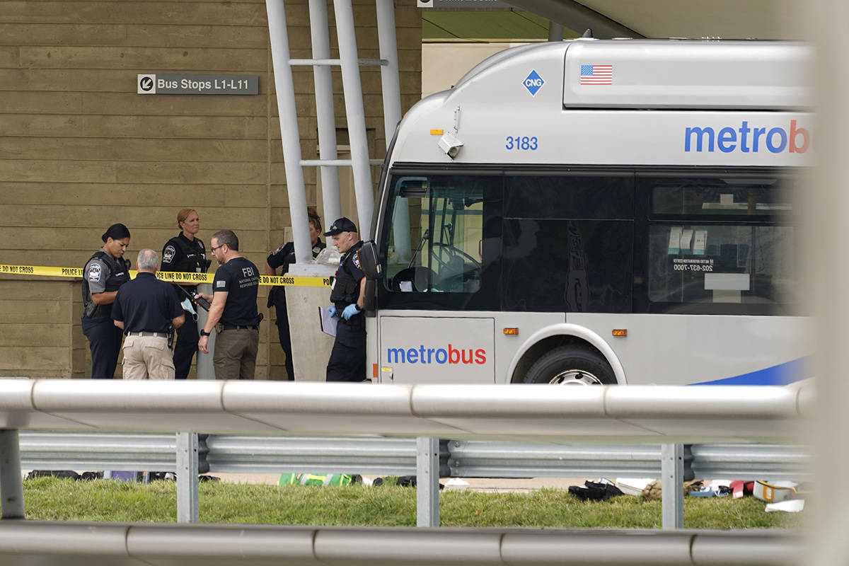 Police are looking at a scene and items are seen on the ground near a Metrobus outside the Pent ...