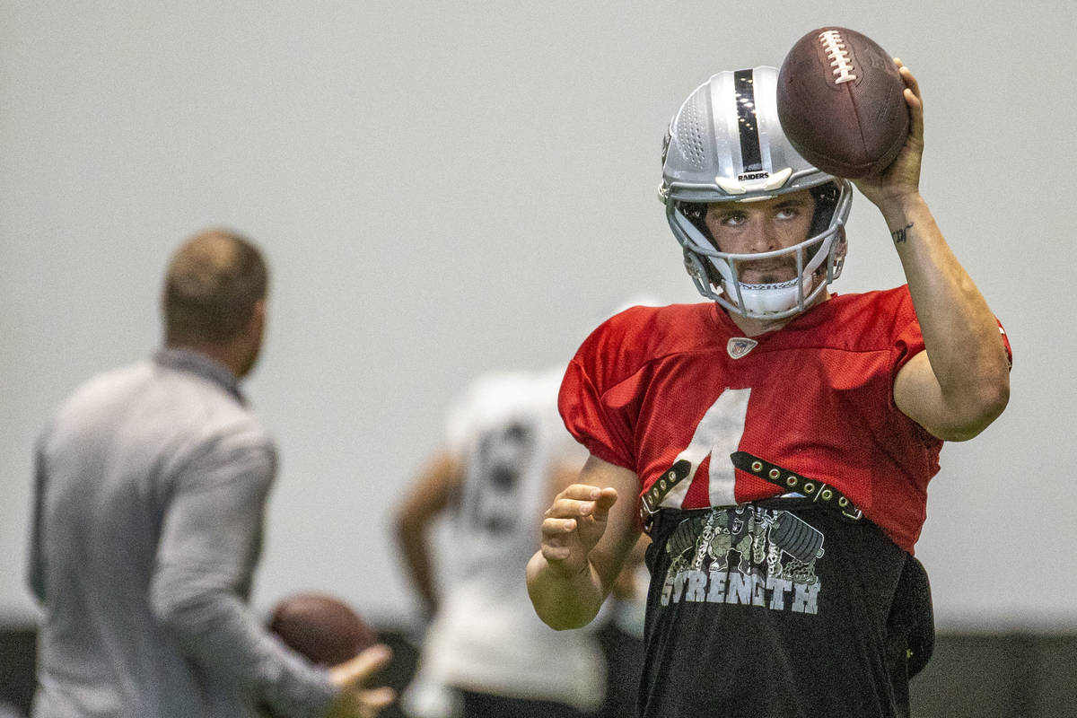 Raiders quarterback Derek Carr (4) signals to a receiver during practice at the Intermountain H ...