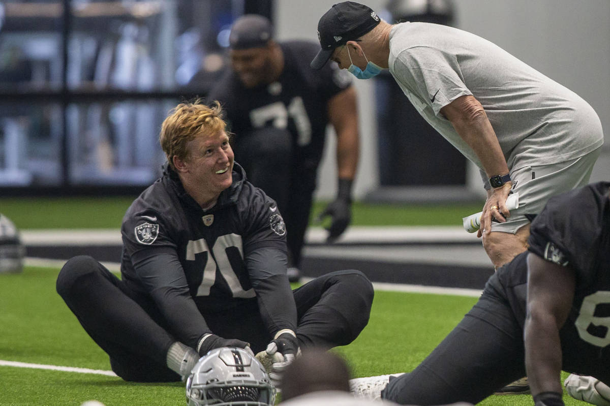 Las Vegas Raiders offensive tackle Sam Young (70) smiles as defensive line coach Rod Marinelli ...