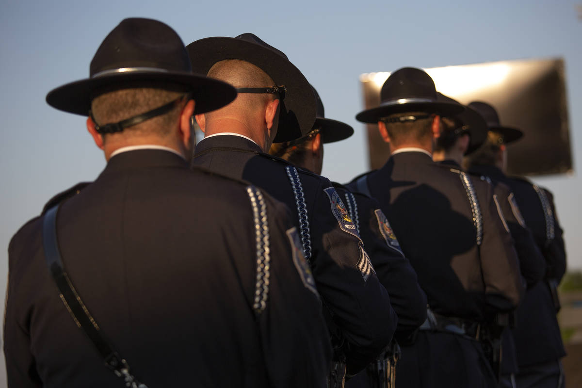 The Honor Guard attends a vigil for fallen Nevada Highway Patrol trooper Micah May at Police Me ...
