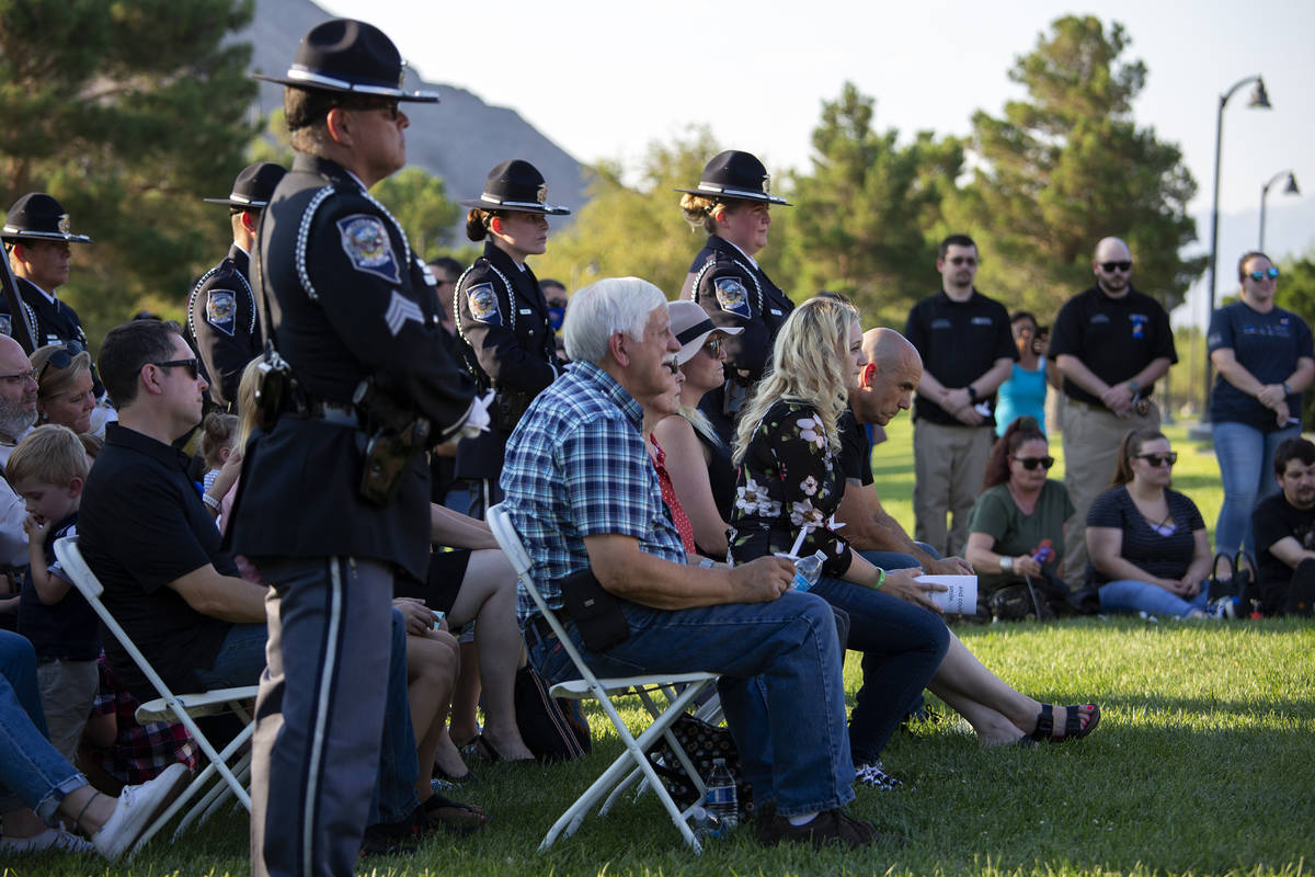 Family, friends and colleagues listen to speakers during a vigil for fallen Nevada Highway Patr ...