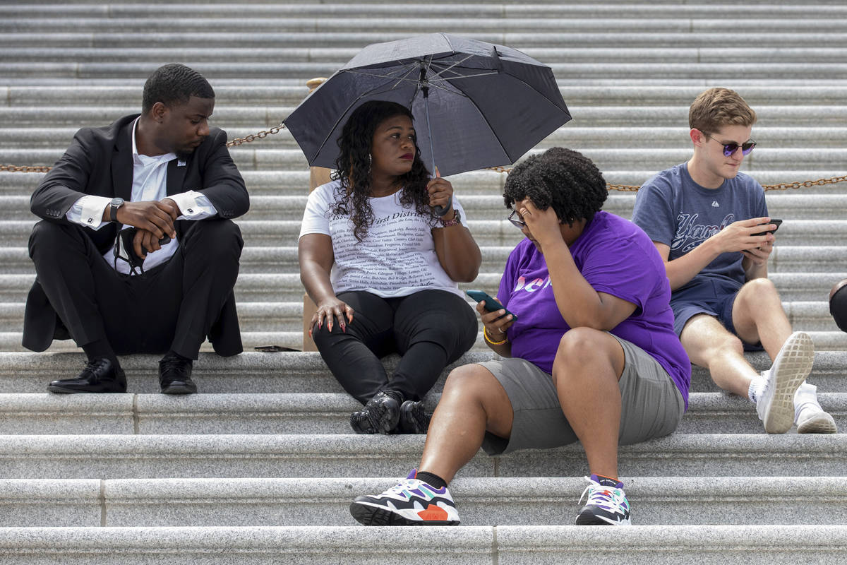 Rep. Cori Bush, D-Mo., second from left, sits with supporters advocating for reinstating the no ...