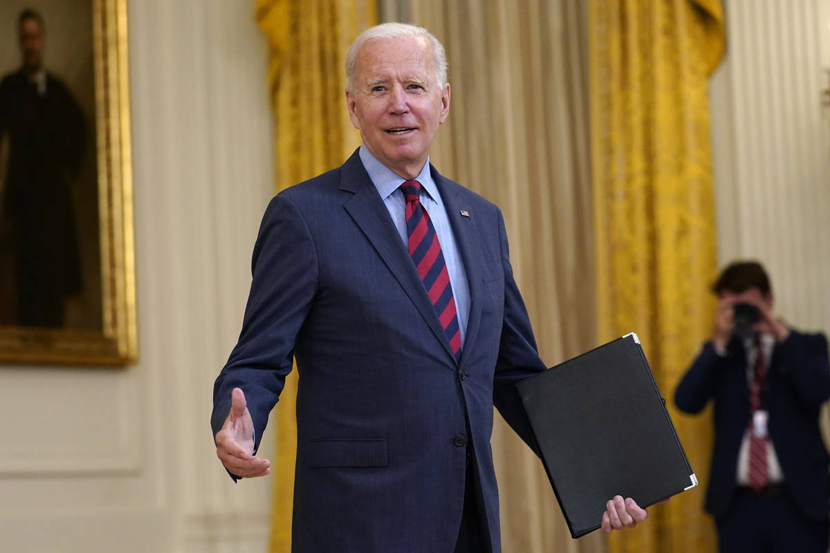 President Joe Biden answers a question from a reporter as he speaks about the coronavirus pande ...