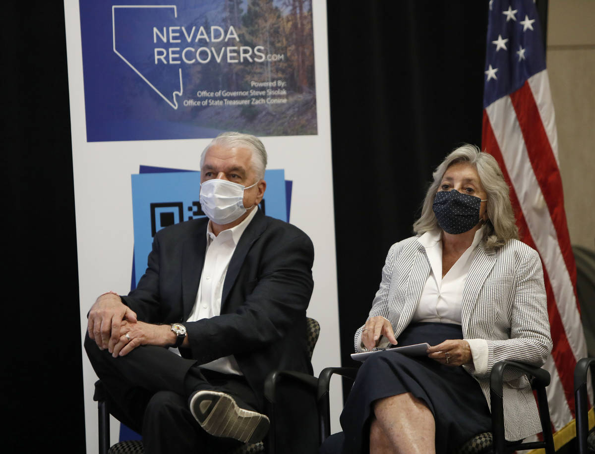 Nevada Gov. Steve Sisolak and Rep. Dina Titus, D-Nev., listen to Nevada State Treasurer Zach Co ...