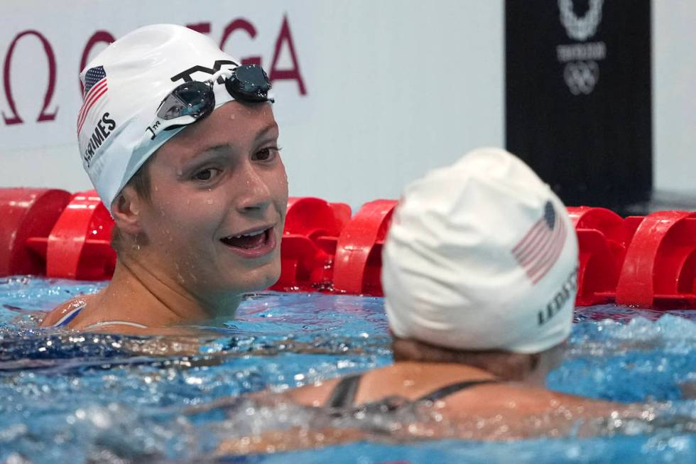 Katie Grimes, left, of the United States, talks with teammate Katie Ledecky, following their he ...