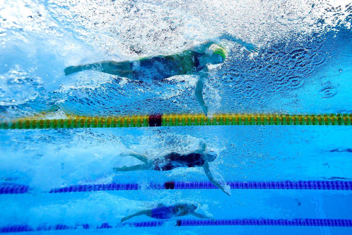 Emma Mckeon, top, of Australia, swims to set an olympic record in a women's 50-meter freestyle ...