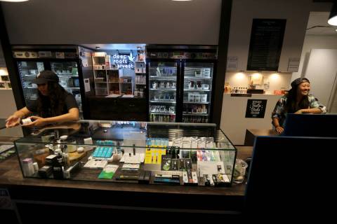Alyssa Jusino, left, and Jezrey Saenz help customers at Exhale Nevada marijuana dispensary in L ...