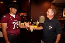 Faith Lutheran coach Mike Sanford and right tackle Vili Fetapai, 78, joke during Southern Nevad ...