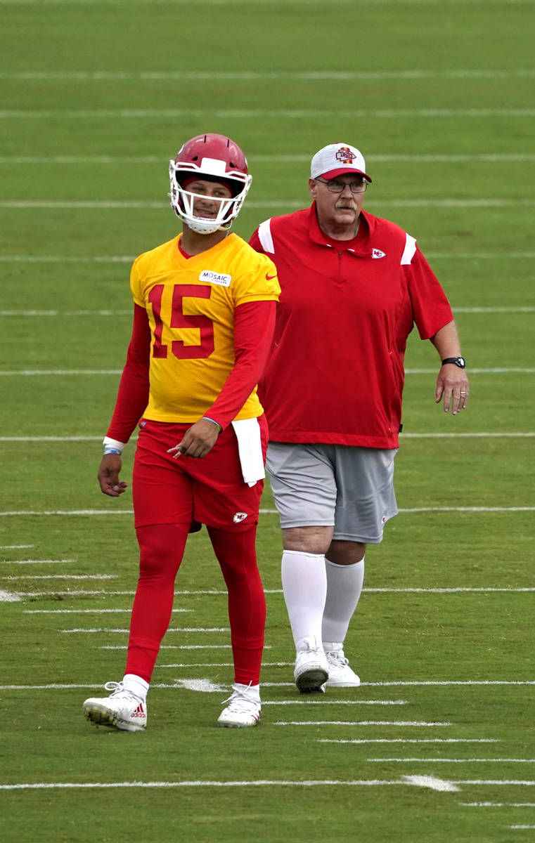 Kansas City Chiefs quarterback Patrick Mahomes (15) and head coach Andy Reid watch teammates du ...