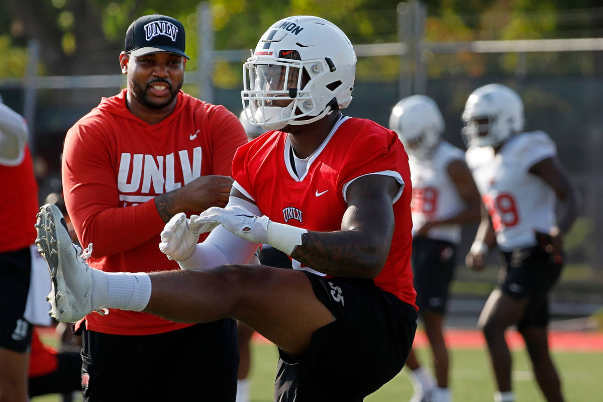 UNLV Rebels linebacker Jacoby Windmon (4), foreground, warms up during football practice in UNL ...
