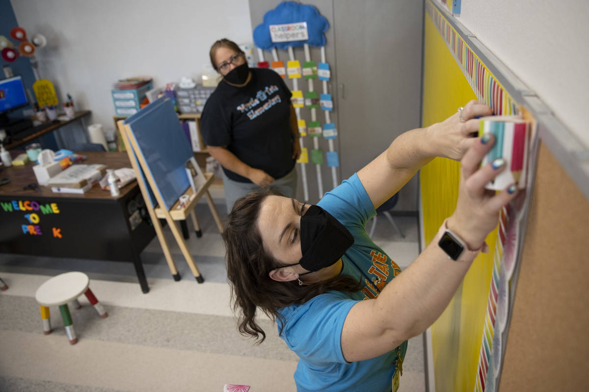 Pre-kindergarten teacher Leigh Todd, right, gets her room ready for the new school year with te ...