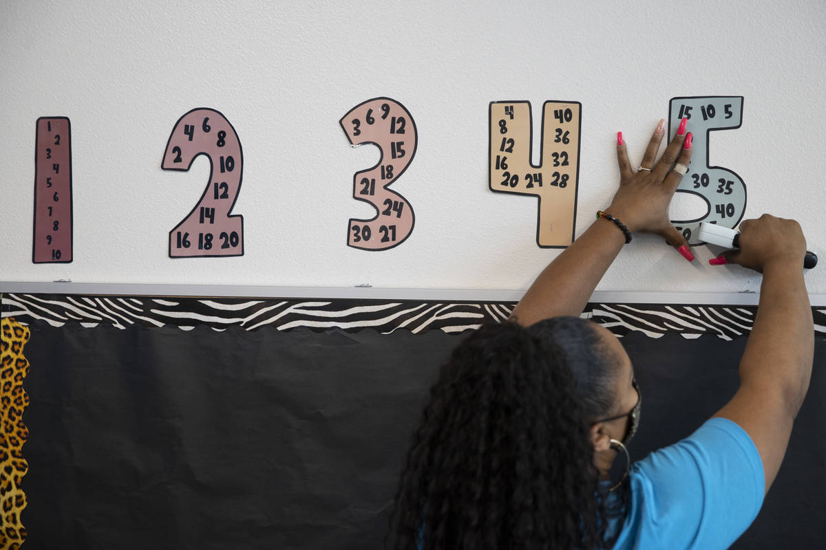 Student physical therapist assistant Shawntae Mauldin gets a classroom ready for the new school ...