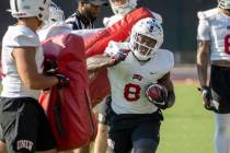 UNLV running back Charles Williams (8) hits a pad on a drill during football team practice at R ...