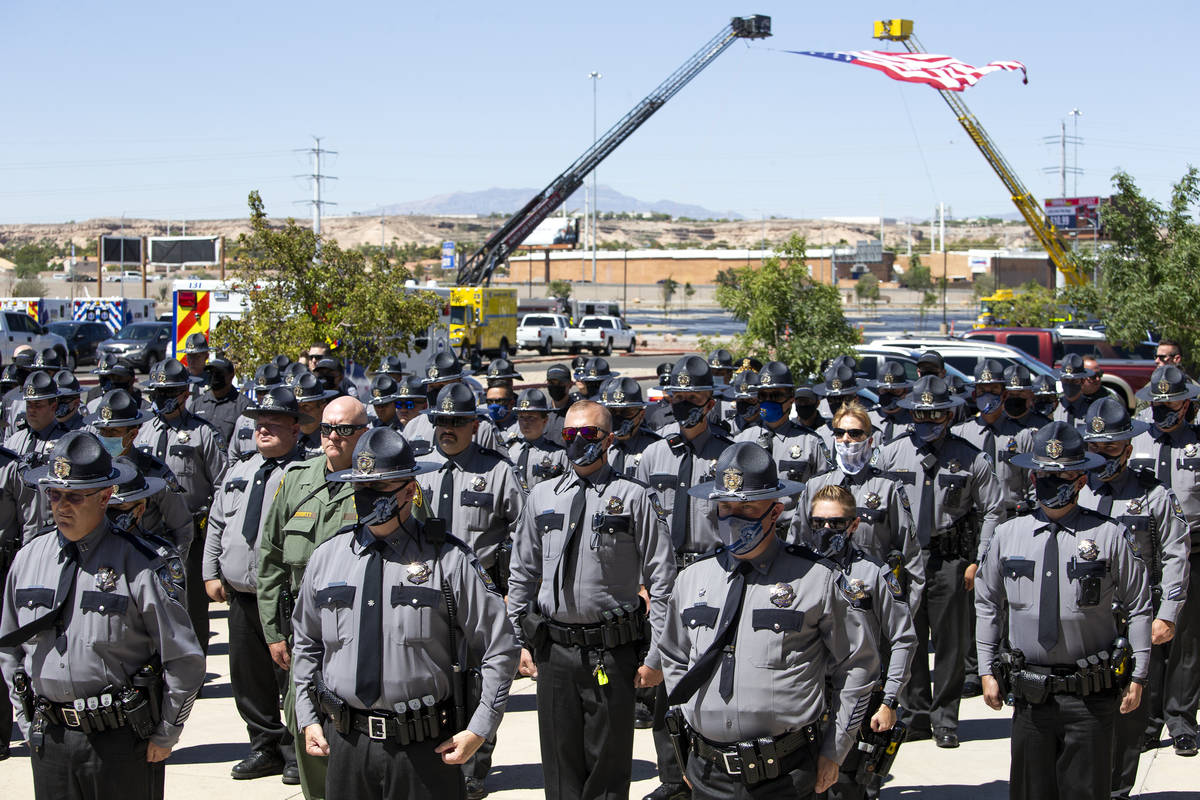 Members of the Nevada Highway Patrol stand at attention as the procession of law enforcement le ...