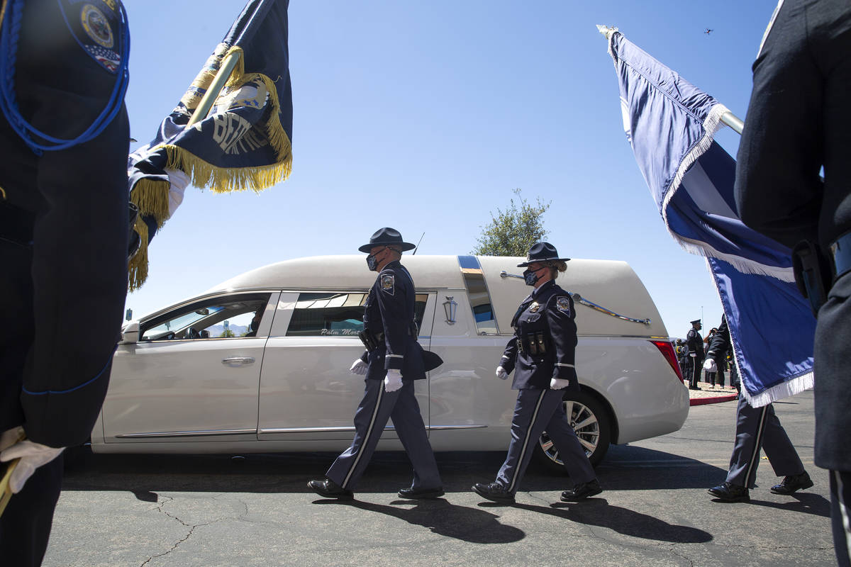 Fallen Nevada Highway Patrol trooper Micah May's casket is lead by procession into his memorial ...