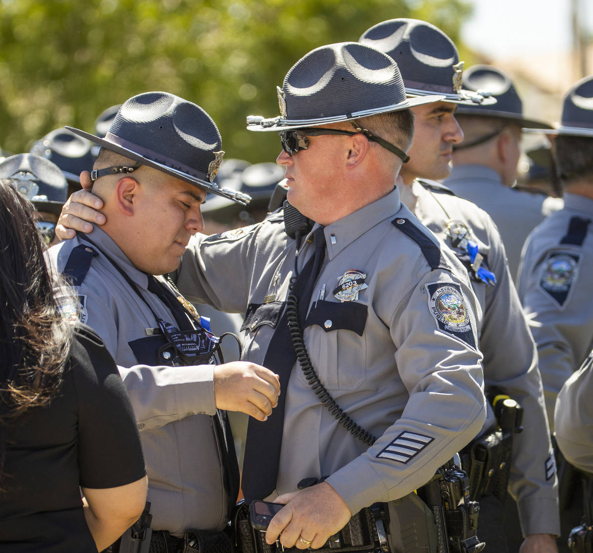 Nevada Highway Patrol troopers comfort each other during a graveside service at Palm Eastern Mo ...
