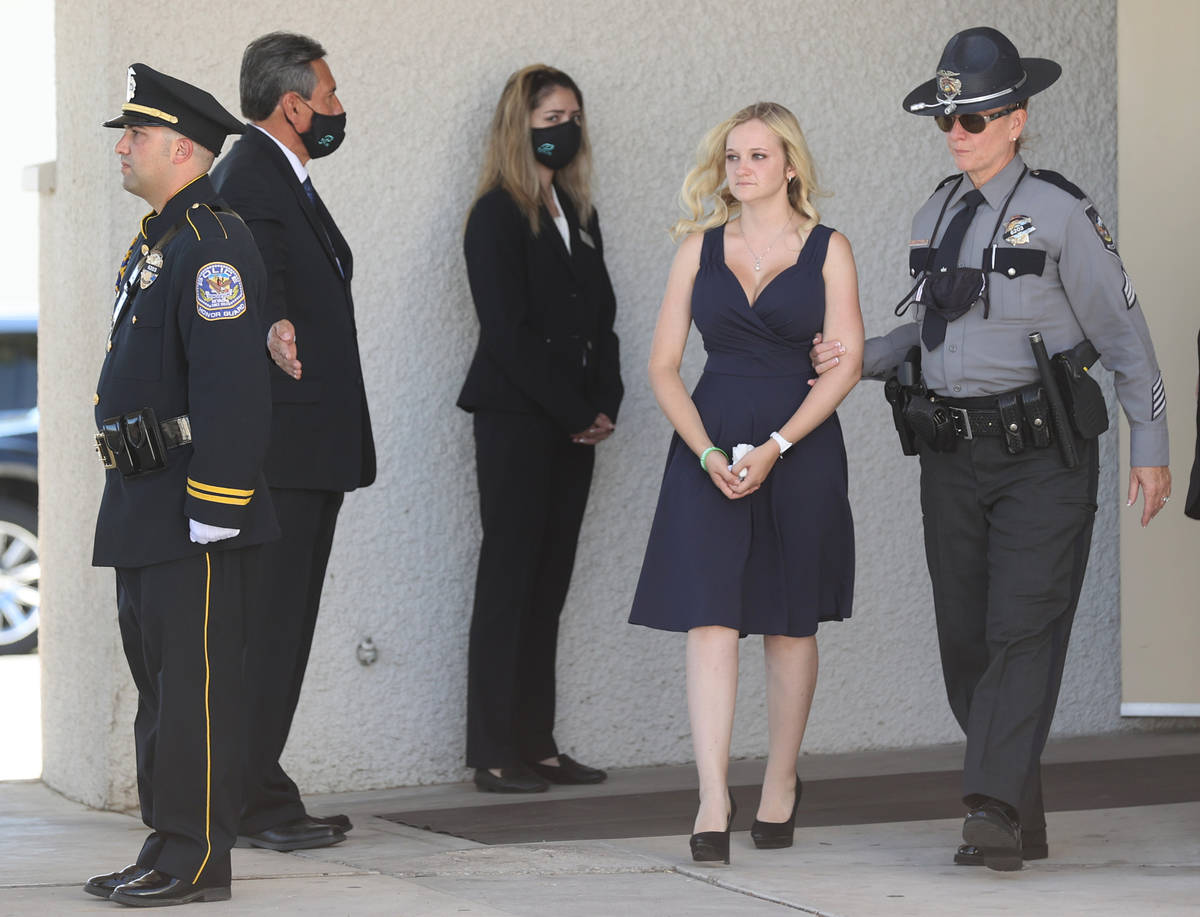 Joanna May, wife of fallen Nevada Highway Patrol trooper Micah May, is escorted by May's Sgt. S ...