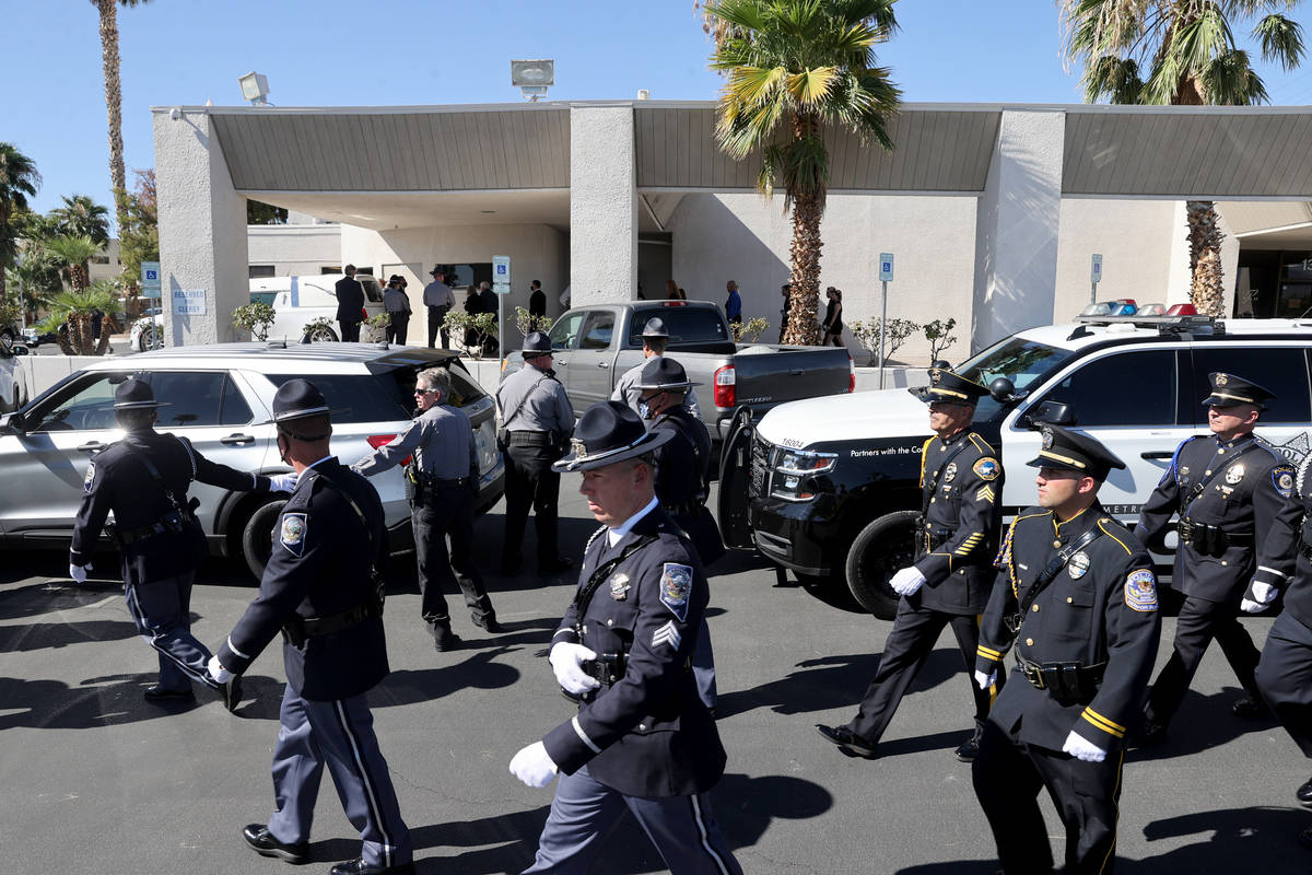 Law enforcement personnel head to their vehicles for the funeral procession for Nevada Highway ...