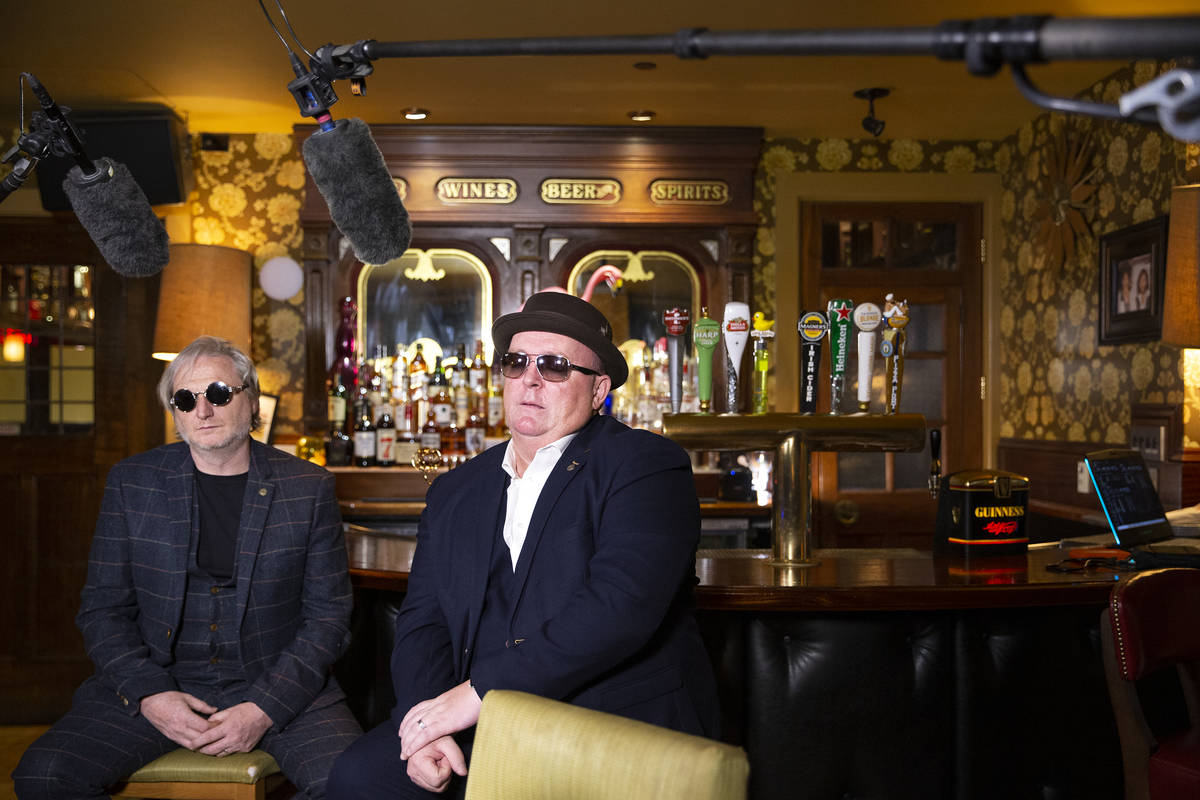 Dave Brown, left, and Dave Rooney, members of local Irish music duo The Black Donnellys, film a ...