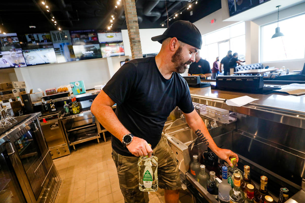Bartender Mark Killgren organizes alcohol at the new PKWY Tavern in Henderson, Thursday, Aug. 5 ...