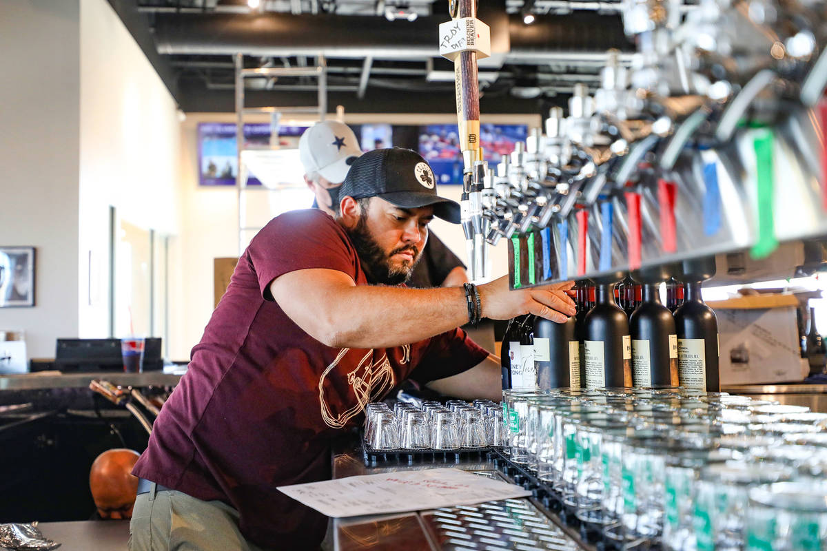 Bartender Edward Parker organizes wine bottles at the new PKWY Tavern in Henderson, Thursday, A ...