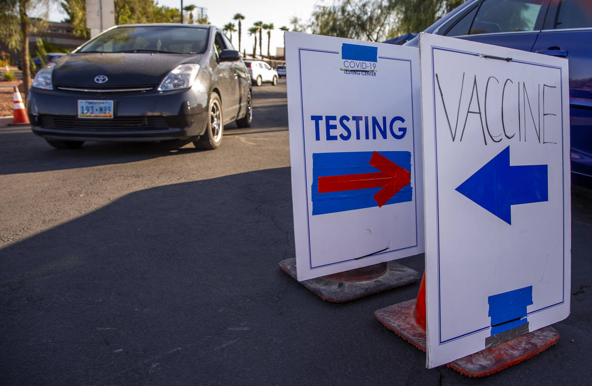 Cars are directed to specific lanes at the drive-thru COVID-19 tests and vaccinations site offe ...